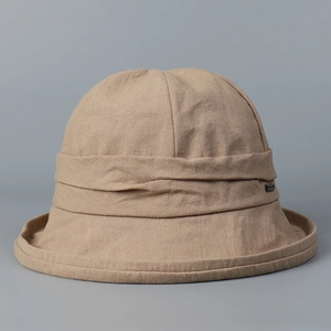 Close-up of a beige linen bucket hat showcasing the breathable fabric texture and detail