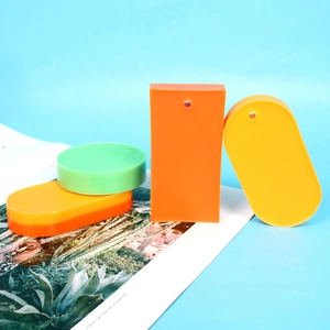 Colorful silicone soap molds in rectangular, oval, and round shapes on blue background