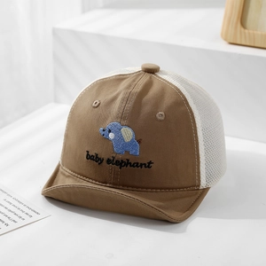Detailed close-up of baby sun hat mesh and cute elephant embroidery on brown cotton fabric