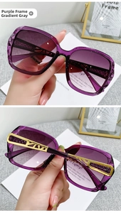 Detailed shot of purple gradient lenses and ornate hollowed-out golden metal temples