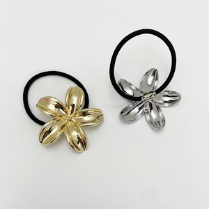 Close-up of gold and silver metallic flower charms on high-elasticity hair ties