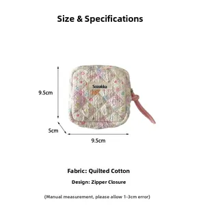 Detail of floral quilted cotton pouch showing zipper closure and dimensions of 9.5x9.5x5cm