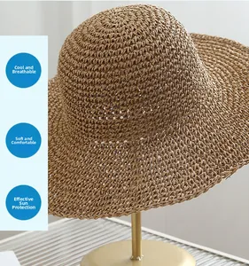 Detail of hand-woven straw sun hat with fine texture on a gold metal display stand