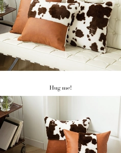 Detail of cow print and brown faux leather patchwork on plush sofa cushion cover