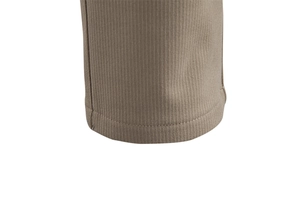 Close-up of tan casual trousers featuring thick vertical ribbed texture and neat hemline