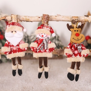 Three plush Christmas ornaments featuring Santa, snowman, and reindeer on a wooden branch