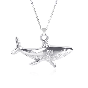 Detailed close-up of a silver shark pendant with realistic gills and fins on a chain