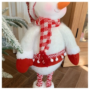 Detailed view of plush snowman christmas decoration with red and white knitted scarf