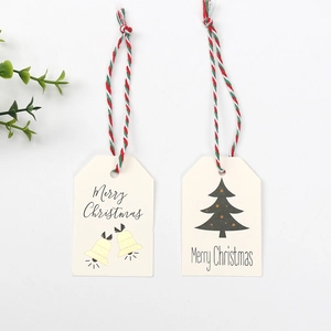 Detail of Merry Christmas gift tags with bells and tree designs and tricolor cotton cords