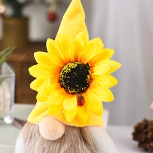 Close-up of fall gnome plush featuring a large sunflower hat and cute ladybug detail