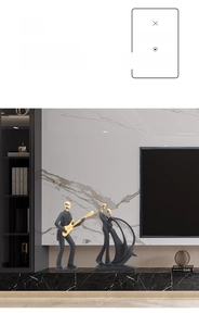Detail of minimalist black resin music band figurine and dancing couple with gold accents