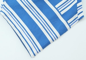 Detail of blue and white striped linen fabric showing texture and neat stitching