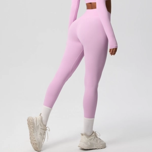 Rear view of pink high-waisted gym leggings showing peach lift effect and bodycon fit