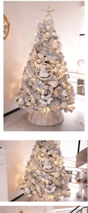 Close-up of silver Christmas tree with warm lights, glitter bows, and star topper