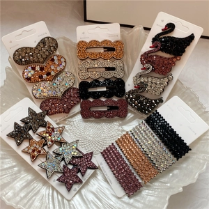 Macro shot of assorted rhinestone hair clips in heart, star and swan shapes on display