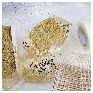 Macro detail of champagne chiffon ribbon with sparkling sequins for Christmas tree decor