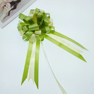 Macro detail of a spherical green and yellow bicolour ribbon bow for gift wrapping