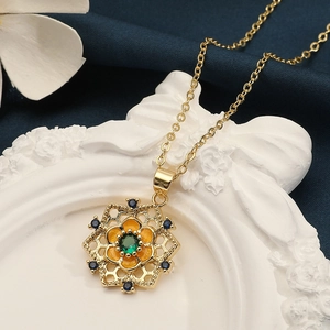 Elegant gold necklace featuring a hexagonal flower pendant with green zircon and blue stones
