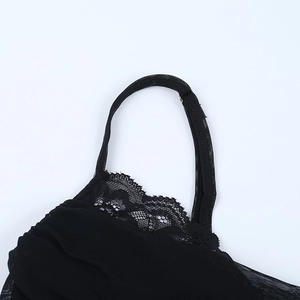 Vue détaillée des bords en dentelle noire et du tissu en maille transparente du caraco