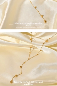 Detail shot of 18K gold plated bead chain necklace with elegant long tassels