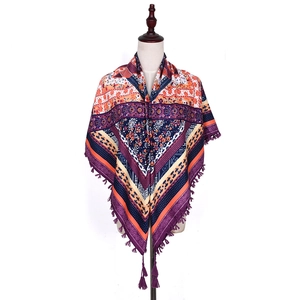 Detail of bohemian ethnic shawl featuring multi-color jacquard patterns and knotted tassels