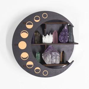 Detail of crescent moon wooden shelf with gold moon phases and crystal display