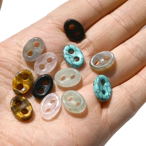 Natural crystal pig nose link beads in tiger eye and quartz shown in hand palm