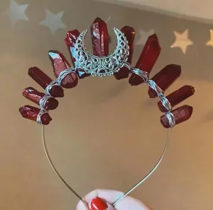 Detail view of handmade moon headband with deep red crystals and silver wire wrap