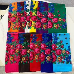 Flat lay of colorful floral Russian style scarves in a variety of vibrant ethnic patterns