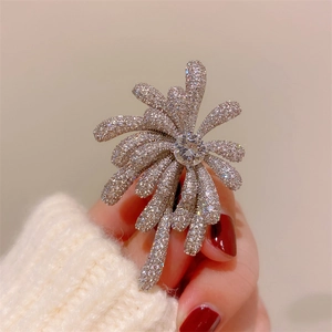 Detailed view of silver zircon brooch featuring a brilliant sparkling fireworks design