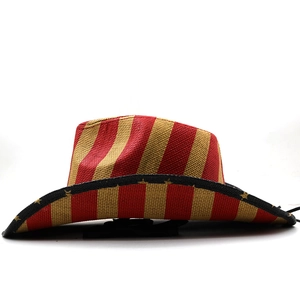 Detail of hand-woven straw cowboy hat featuring red and yellow stripes with star patterns