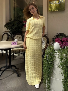Detail of light yellow knit two-piece set with wave crochet pattern and polo collar