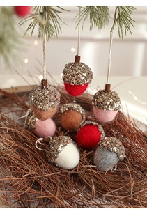 Close-up of handmade felt pinecone Christmas ornaments with glitter details and hemp ropes