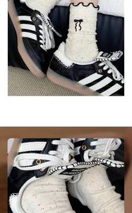 Detailed view of classic black and white sneakers with iconic three stripes and rubber sole