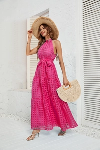 Detail of fuchsia checkered halter neck maxi dress with layered ruffle skirt and waist tie