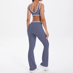 Detail of high-waist flared yoga pants and racerback top with white contrast piping