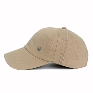 Close-up of Freestyle embroidery and metal shield badge on khaki cotton baseball cap