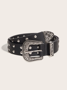 Detail of western style black leather belt with ornate silver buckle and metal rivets