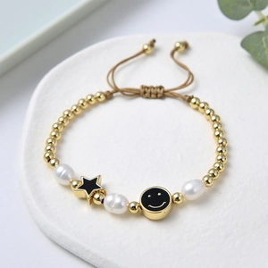 Detail of adjustable beaded bracelet with freshwater pearls and star smiley charms