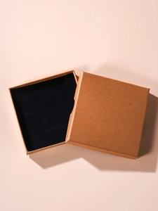 Top view of minimalist kraft paper jewelry gift box with black foam insert and lid