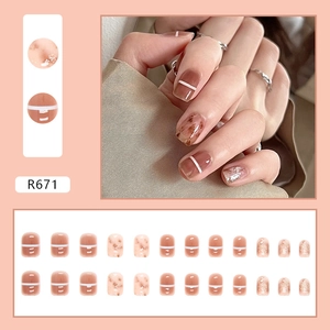 Glossy amber tea-colored press-on nails with white lines and gold foil accents