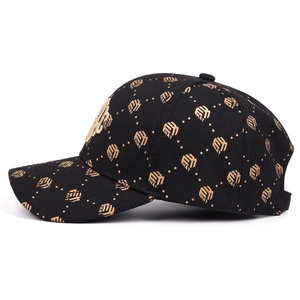 Fashion baseball cap featuring 3D gold embroidery and all-over logo print in black