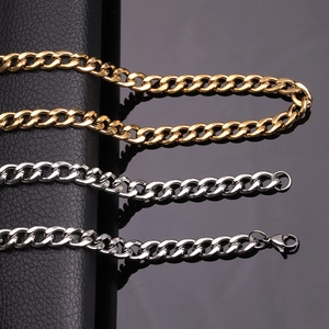 Detailed shot of gold and silver stainless steel Cuban link chains with lobster clasps