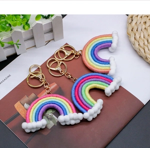 Close-up of handmade macrame rainbow keychains with soft cotton ropes and gold clasps