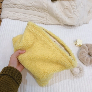 Detailed interior view of a soft yellow fleece handbag showing lining and zipper closure