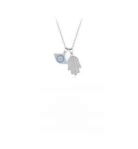 Macro detail of S925 sterling silver evil eye and Hamsa hand pendant with blue zircons