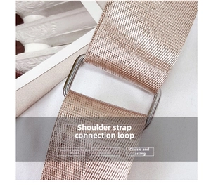 Detail of champagne gold woven nylon bag strap with polished silver metal link connector