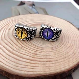 Detail of vintage punk devil eye rings with yellow and purple dragon eye stones