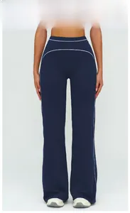 Detail of high-waisted emblem blue wide-leg pants featuring white contrast stitching