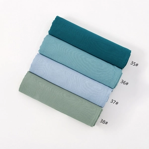 Detail showing soft modal hijab fabric in gradient shades with premium edge stitching